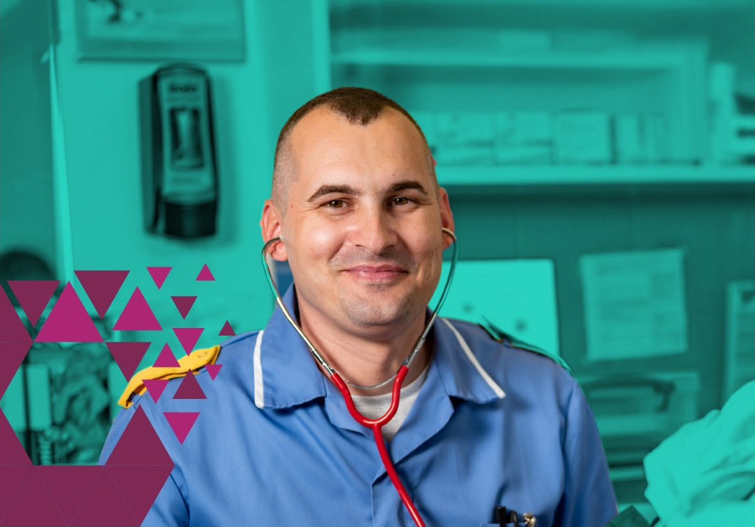 A smiling male nurse in blue scrubs wearing a stethoscope, with colorful abstract shapes overlaying a blurred medical backdrop.